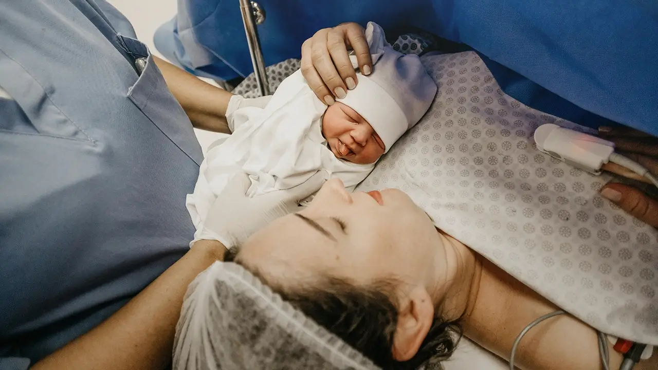 Mother meets her newborn baby right after delivery in a hospital setting